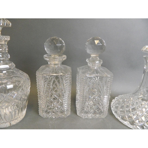 46 - A matched pair of cut glass decanters, together with a cut glass ship's decanter, and another, large... 