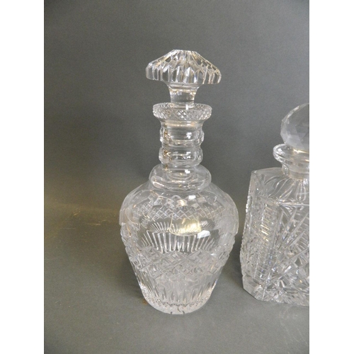 46 - A matched pair of cut glass decanters, together with a cut glass ship's decanter, and another, large... 