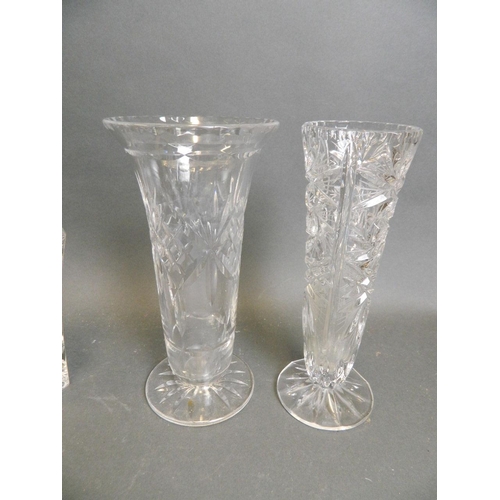 48 - A collection of three cut glass vases, together with a pair of triform crystal vases with cranberry ... 