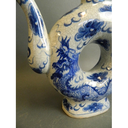 49 - A Chinese blue and white porcelain teapot with hollow body and crackle glazed dragon and flaming pea... 