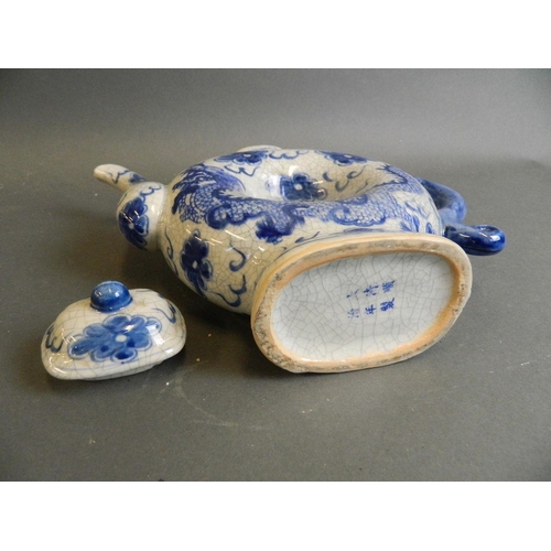 49 - A Chinese blue and white porcelain teapot with hollow body and crackle glazed dragon and flaming pea... 