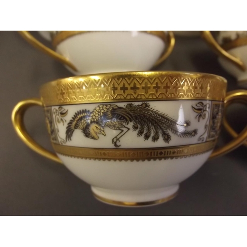 50E - A set of 6 Limoges porcelain twin handled cups decorated in black and gilt with exotic birds within ... 