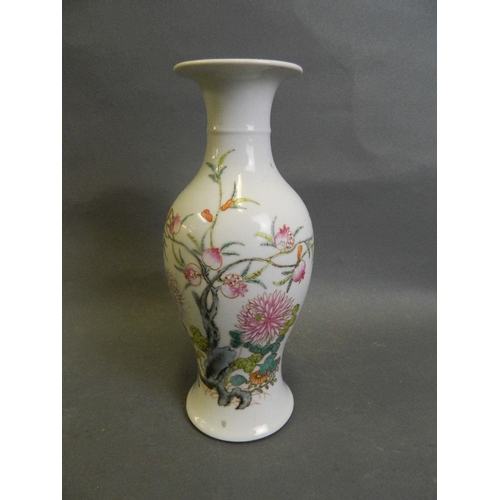 50S - A Chinese polychrome enamel porcelain vase with painted decoration of a pomegranate tree and flowers... 