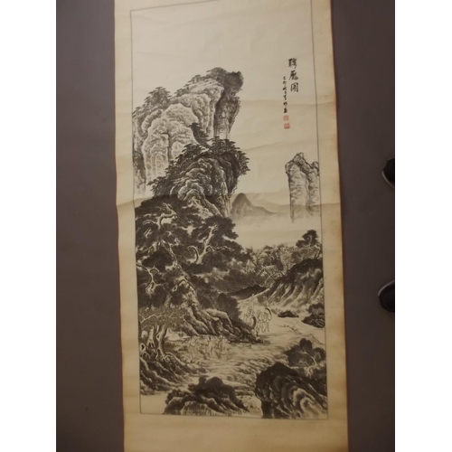 50Y - A Chinese black and white scroll depicting travellers in a mountain landscape, signed in calligraphy... 