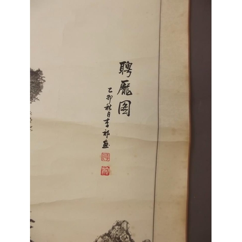 50Y - A Chinese black and white scroll depicting travellers in a mountain landscape, signed in calligraphy... 