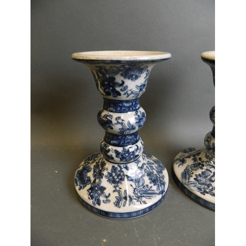 7 - A pair of Oriental crackle glazed porcelain candlesticks with blue and white decoration of birds, fr... 