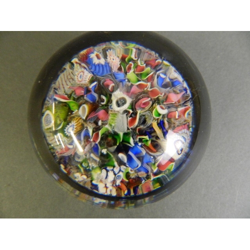 100 - A fine Millefiori glass paperweight with multiple rods and leaves, possibly Baccarat, 2½