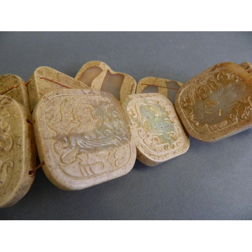 102 - A Chinese archaic jade belt with carved decoration of an immortal, 31