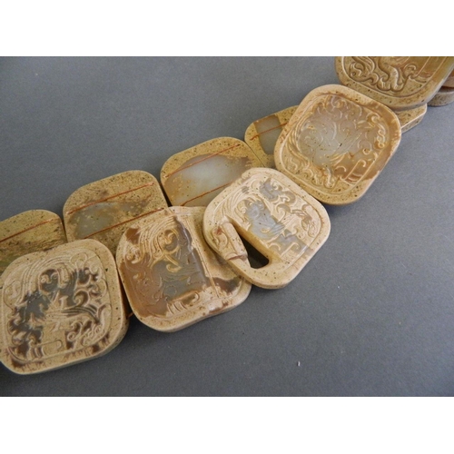 102 - A Chinese archaic jade belt with carved decoration of an immortal, 31