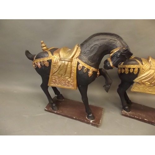 104 - A pair of French carved and painted wood figures of horses, 28