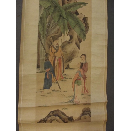 113 - A Chinese watercolour scroll depicting four figures beneath a rocky outcrop, 12½