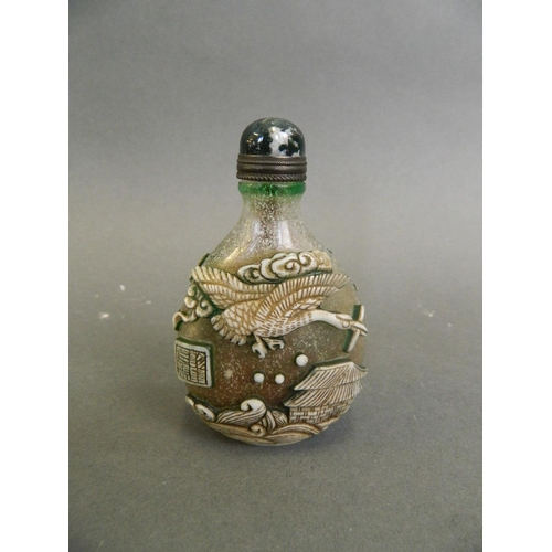 122 - A Chinese glass snuff bottle with applied carved decoration of carp and storks, 3