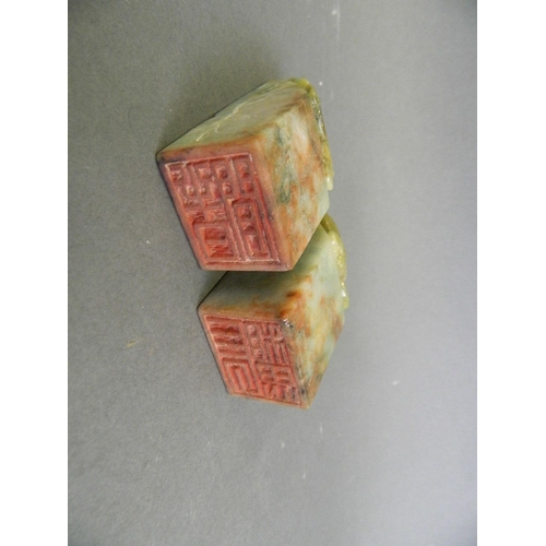 135 - A pair of Chinese marbled green and brown jade seals with carved phoenix and dragon decoration, 3