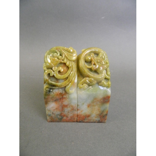 135 - A pair of Chinese marbled green and brown jade seals with carved phoenix and dragon decoration, 3