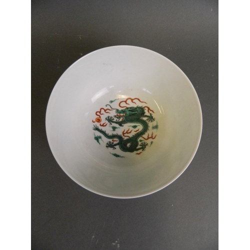 138 - A Chinese famille verte enamelled porcelain bowl decorated with dragons chasing the flaming pearl, 6... 