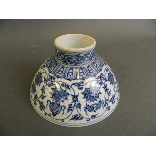 142 - A Chinese blue and white porcelain footed bowl decorated with lotus flowers and the eight Buddhist s... 