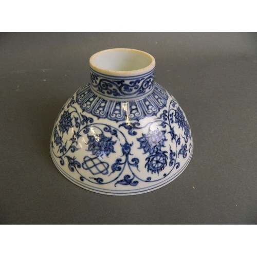 142 - A Chinese blue and white porcelain footed bowl decorated with lotus flowers and the eight Buddhist s... 