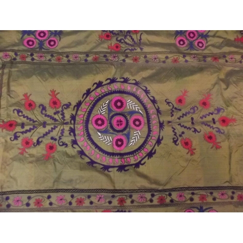 150N - A Susazni green ground silk wall hanging with embroidered floral medallion decoration, 53