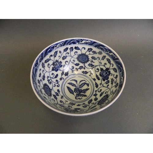 162 - A Chinese blue and white porcelain bowl with scrolling floral decoration, 6 character mark to base, ... 