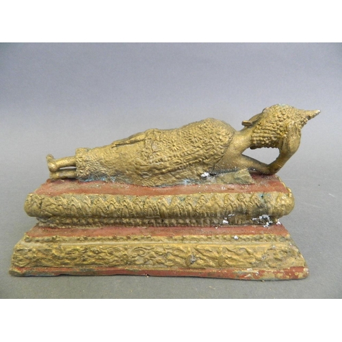 165 - A painted cast brass figure of Buddha reclining, 6½