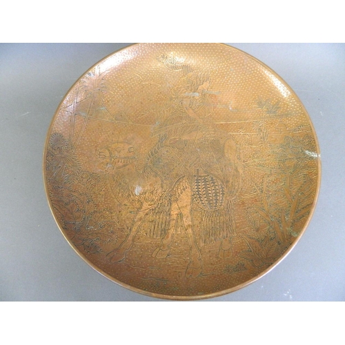 169 - A brass and copper tazza, the top with engraved decoration of an Arab soldier riding a camel, 11