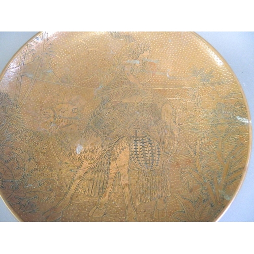 169 - A brass and copper tazza, the top with engraved decoration of an Arab soldier riding a camel, 11