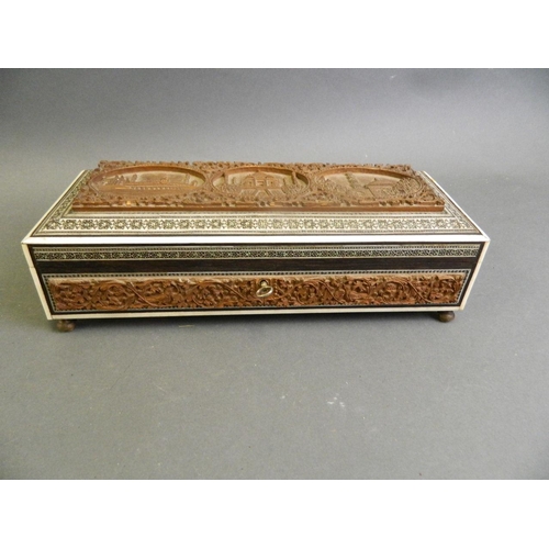 172 - An Indian micro-mosaic glove box with carved hardwood decorative panels depicting the Taj Mahal, 12