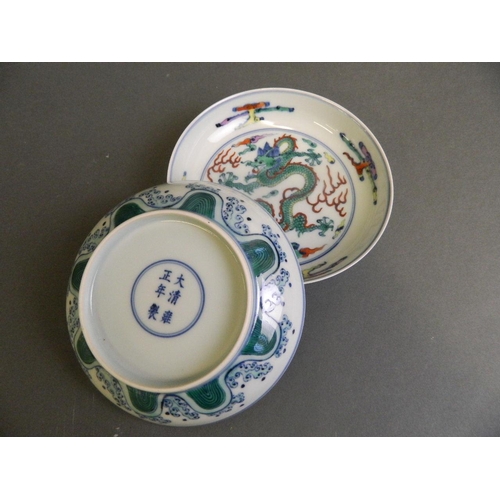 175 - A pair of Chinese Doucai enamelled porcelain trinket dishes decorated with a dragon chasing the flam... 