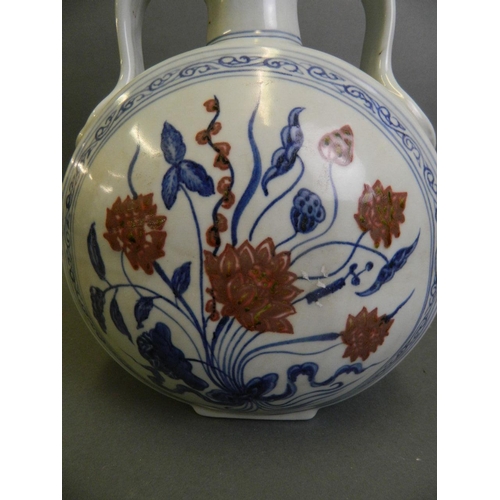 187 - A Chinese twin handled blue and white porcelain moon flask with painted lotus flower decoration and ... 