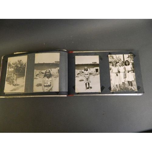 188 - A Persian foil covered photo album decorated with a mosque and a lion hunt scene, with a collection ... 