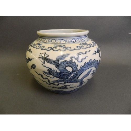 194 - A Chinese Ming style blue and white porcelain jardinière with twin dragon decoration, 6 character ma... 