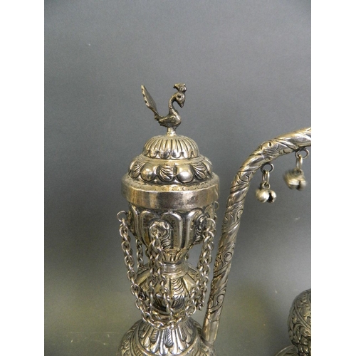 197 - A pair of Middle Eastern mixed metal hand-held hookah pipes with scrolling foliate repoussé decorati... 