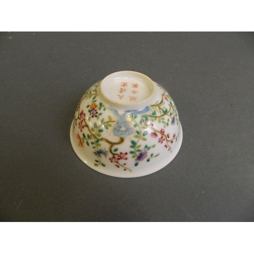 199 - A Chinese polychrome enamel tea bowl decorated with flowers in bloom, 6 character mark to base, 4