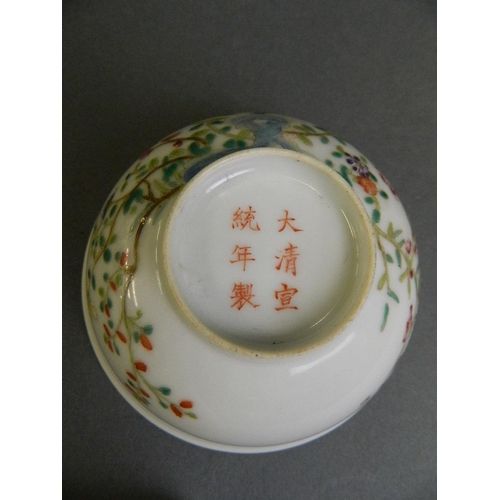 199 - A Chinese polychrome enamel tea bowl decorated with flowers in bloom, 6 character mark to base, 4