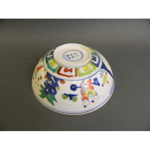 206 - A Chinese Doucai enamelled eggshell porcelain bowl decorated with boys playing in a garden, 6 charac... 