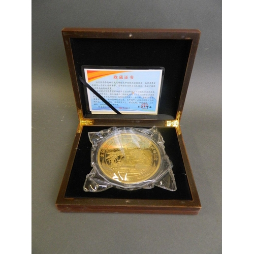 207 - A large Chinese gilt plated metal coin commemorating Beijing's candidacy for the 2022 Winter Olympic... 