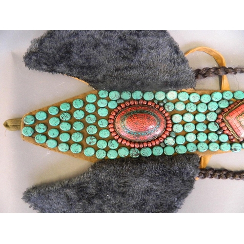 208 - A Tibetan ceremonial tribal hat decorated with coral, turquoise, shell and white metal beads, 33½