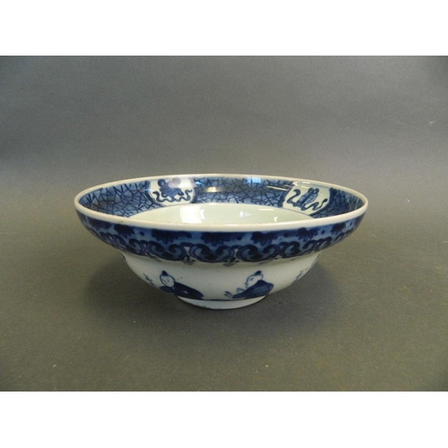 218 - A Chinese blue and white porcelain bowl decorated with nine boys playing in a garden and twin kylin ... 