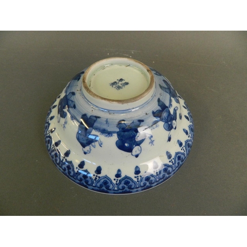 218 - A Chinese blue and white porcelain bowl decorated with nine boys playing in a garden and twin kylin ... 