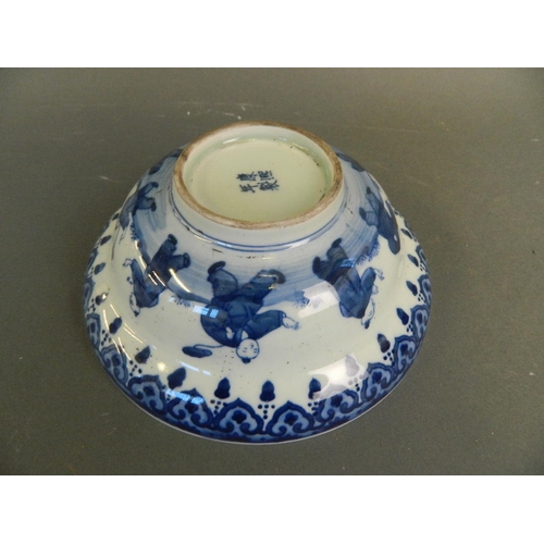 218 - A Chinese blue and white porcelain bowl decorated with nine boys playing in a garden and twin kylin ... 