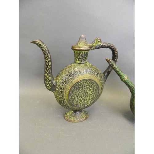 221 - An Eastern bronze ewer with Islamic style moulded decoration and green patina, together with another... 