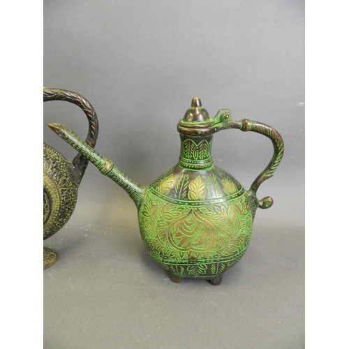 221 - An Eastern bronze ewer with Islamic style moulded decoration and green patina, together with another... 