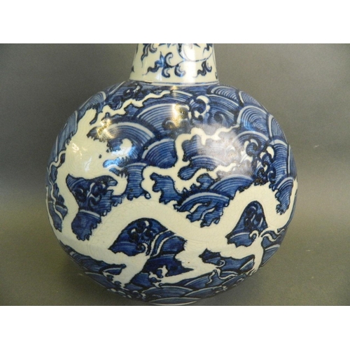 223 - A Chinese blue and white porcelain moon flask with incised dragon decoration, 2 character mark to ba... 