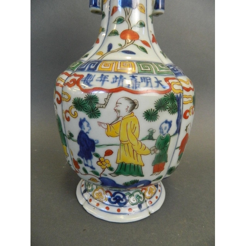 247 - A Chinese Wucai enamel porcelain vase with twin jug handles and painted decoration of figures beneat... 