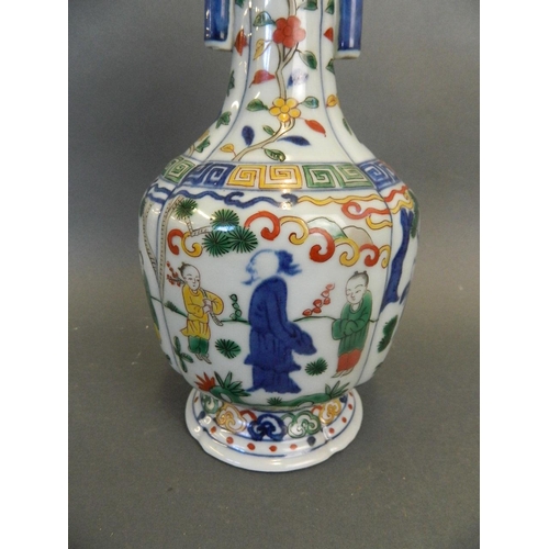 247 - A Chinese Wucai enamel porcelain vase with twin jug handles and painted decoration of figures beneat... 