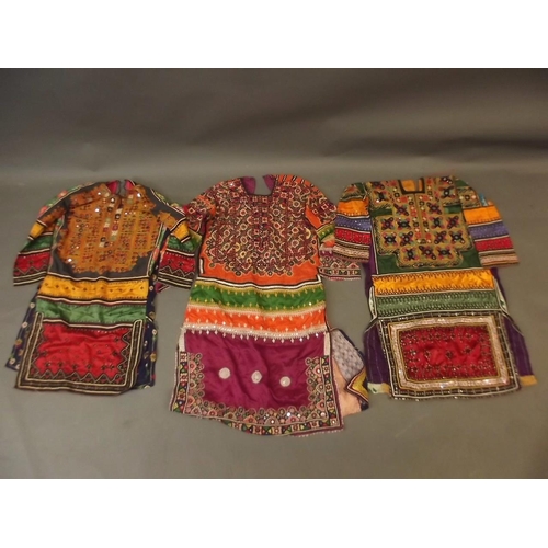 250A - A collection of three Middle Eastern lady's silk dresses with mirror bead and embroidered decoration... 