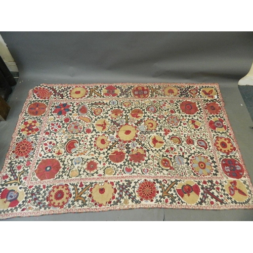 250C - A large antique Uzbek white ground wall hanging with silk embroidered floral decoration, c1900, 90