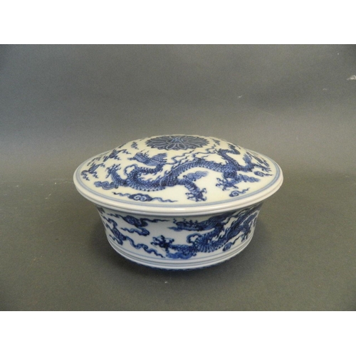 258 - A Chinese Ming style blue and white porcelain bowl and cover with painted dragon decoration, on a fo... 