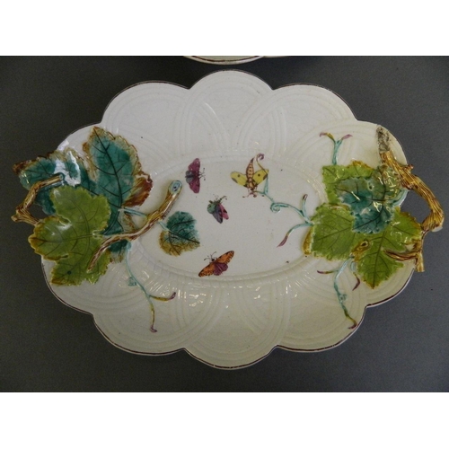 26 - A pair of late C18th/early C19th porcelain oval dishes with moulded leaf and painted butterfly decor... 