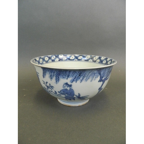 262 - A Chinese blue and white porcelain rice bowl decorated with figures in a garden, 4 character mark to... 